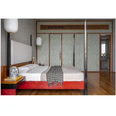 The master bedroom, featuring a custom four-poster bed and wardrobe panels with a subtle, elegant pattern. The design creates a serene and restful retreat.