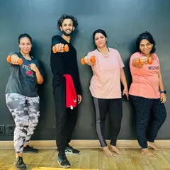Fitness is a journey, and we're here to guide you. Our members using dumbbells for a strength-focused Zumba session. We offer both morning and evening batches.