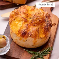 Our freshly baked Focaccia Bread, topped with potato slices and rosemary. It's soft, chewy, and perfect for dipping or enjoying on its own.
