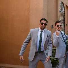 A candid shot of one of the groomsmen, full of personality and fun, enjoying the celebration.