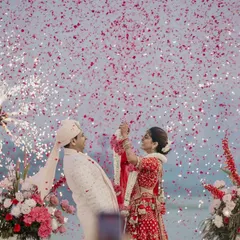 The peak of the varmala, with cold pyros and a shower of petals creating a truly spectacular moment. This is what a grand wedding celebration looks like.