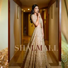 A stylish and playful portrait of the bride in a beautifully lit hallway.