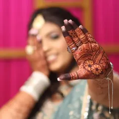 A happy bride showing off her gorgeous, dark henna stain. The color is rich and even, making the intricate details pop.