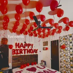 A classic red-themed birthday room decoration. I covered the ceiling with red balloons and used foil letters for the birthday wish over the bed.