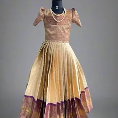 Another adorable kids' lehenga, custom-made from a semi-Kanchi saree. The rich gold and purple combination gives a festive and royal look, perfect for family functions and weddings.