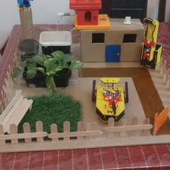 Here is the complete sustainable city model, a project that required weeks of planning and building. The model includes renewable energy sources, green spaces, and even a robotic car, showcasing a deep understanding of urban sustainability.