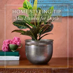 A home styling tip from me: don't be afraid to mix metal finishes. Combining different metals like the bronze of this planter with other accents can create a layered, sophisticated look with depth and contrast.