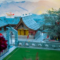 A beautiful, sunlit shot of a traditional Himachali temple against the backdrop of the mountains. I look for these perfect moments where light and landscape come together to create a divine feeling.