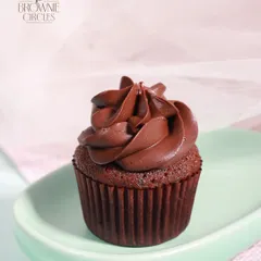 Our humble but delicious Chocolate Ganache Cupcake, topped with a rich and silky swirl of pure chocolate ganache.