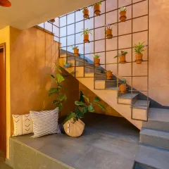 The central staircase in the Terravana Villa is more than a functional element; it's a vertical garden and a visual anchor. The design uses a simple steel grid for planters, turning the transition between floors into a living, breathing feature that infuses the home with nature.