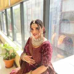 A full-length view of the royal bride, showcasing the harmony between the makeup, velvet lehenga, and heavy jewelry. My course covers how to style a complete and cohesive bridal look.