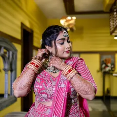 A beautiful shot of the bride getting ready, adjusting her earrings. These quiet, behind-the-scenes moments are an important part of the wedding story.