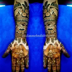 This full bridal mehndi shows how I can weave your story into the design. It features custom portraits of the couple on the palms, the groom's name 'Faijal' elegantly written on the wrist, and is framed by architectural jharokha motifs for a truly regal look.