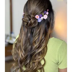 A closer look at the beautiful arrangement of pressed flowers in this unique hairstyle.
