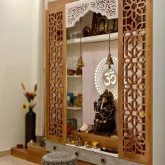 A side view of the temple design, highlighting the detailed craftsmanship of the wooden jali doors and the elegant marble base with drawers for storage.