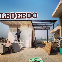 Here you can see a porta cabin and an adjoining pergola under construction on a spacious terrace. This setup is ideal for creating a home office or guest room with its own private, shaded sit-out area.