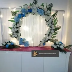 For a minimalist aesthetic, I designed this simple half-arch floral frame. Made with white and blue artificial flowers, it's a clean and modern way to decorate your mandir space for Ganesh Chaturthi.