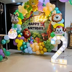 A vibrant jungle-themed balloon ring for a second birthday. We used a custom Lion King inspired backdrop, animal foil balloons, and a large marquee number '2' to complete the look.