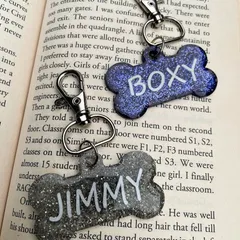 A pair of custom dog tags for 'Boxy' and 'Jimmy'. You can choose the color and glitter to perfectly match your pet's personality.