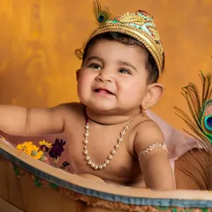 My Little Krishna! Themed shoots like this are a wonderful way to celebrate your culture and create unique memories. I provide all the props, including the tiny crown and peacock feathers.