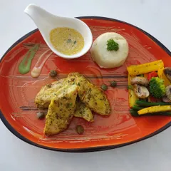 A complete and balanced meal option from our healthy menu. This plate features herb-grilled chicken, mashed potatoes, and a side of sautéed vegetables like bell peppers, broccoli, and mushrooms.