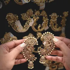 These celebrity-style ear cuffs with a Ganesha motif and jhumka drops are a very popular and trending design. They give a full, grand look without needing a necklace.