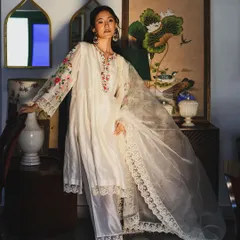 An elegant full-length portrait for the brand Baavli. The composition highlights the flow of the fabric and the intricate embroidery of this beautiful white ensemble.