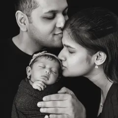 There is a timeless power in black and white photography. It strips away distractions and focuses on the pure emotion of the moment, like the tender, quiet love between new parents and their baby. These are the portraits that become family heirlooms.