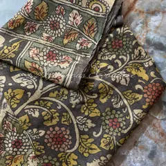 This image shows the rich texture and fold of the silk fabric, highlighting the hand-painted details and the natural variations in the vegetable dyes.