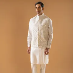 This ivory Jawahar jacket is adorned with intricate threadwork and shimmering mirror details. It is the epitome of grace for the spring season, perfect for adding a touch of sparkle to your ensemble.