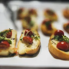 A classic Italian starter, my bruschetta features crisp toasted bread topped with fresh cherry tomatoes, herbs, and a drizzle of balsamic glaze. It's a simple, fresh, and always popular choice.