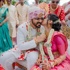 A vibrant varmaala ceremony with colorful smoke, creating a truly spectacular and modern moment. We love capturing both the tradition and the unique personality of your wedding.