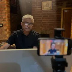 Preparing for an online discourse from my home studio. The setting is designed to be calm and inviting, reflecting the nature of the conversations we have.
