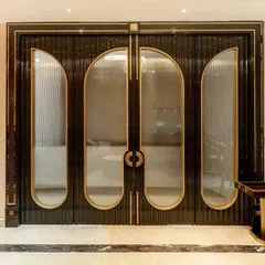 The entrance to this luxury jewelry boutique was conceived as a statement of pure elegance. I designed these custom doors with fluted glass, brass accents, and intricate handles to create a dramatic and exclusive entryway that sets the tone for the opulent experience within.