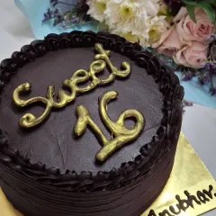 A rich and decadent dark chocolate cake I made for a Sweet 16 birthday. The cake is covered in smooth chocolate ganache and features elegant, handcrafted golden lettering for a sophisticated look.