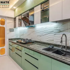 This kitchen design uses a combination of pastel green and white cabinets for a fresh, modern look. The textured backsplash and granite countertop add a touch of sophistication, while the custom door adds a pop of color.
