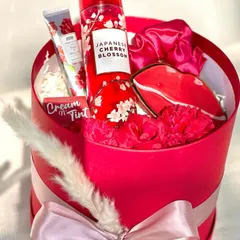 For the one whose favorite color is red! This round box hamper is filled with a Bath & Body Works "Japanese Cherry Blossom" fragrance mist, a lip-shaped trinket dish, and other red-themed goodies.