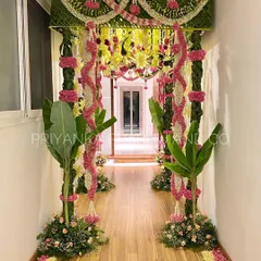 A warm welcome starts at the doorway. I designed this beautiful entrance using traditional elements like banana plants, woven coconut leaves, and garlands of jasmine and roses to create an inviting passage for a pre-wedding celebration.