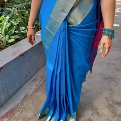 Showcasing the beauty of a South Indian style drape on a client. The pre-pleated Mysore silk saree falls elegantly, making it perfect for a festive occasion or a family function.