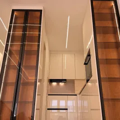 This angle highlights the verticality of the design. The floor-to-ceiling display units draw the eye upward and create a sense of grandeur, while the LED strips provide beautiful ambient lighting.