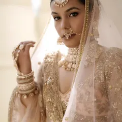 A sleek and polished bridal updo is the perfect way to showcase intricate jewelry like this maang tikka and choker. It's a timeless and regal choice.