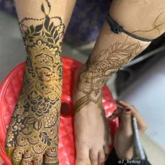 This shot captures the moment of creation, as I add details to a bridal foot design using my smooth-flowing organic henna.