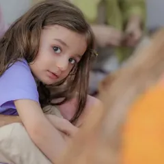 A quiet, candid portrait of a young girl. Her direct gaze and natural expression create a simple yet powerful image that shows her personality.