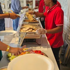 My team member serving guests at a football-themed birthday party. We ensure every guest is taken care of, from small gatherings to larger events.
