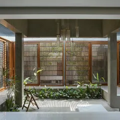 The central courtyard in "The Mantle" project, designed as an extension of the living area. We used slatted screens and lush planting to create a private, sun-dappled oasis within the home.