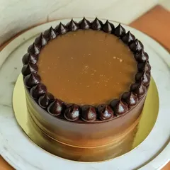 A decadent chocolate cake with a glossy salted caramel drip. It's a simple, elegant, and absolutely irresistible treat.