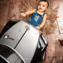 This little mechanic is ready to get to work. The rustic, industrial feel of the garage theme provides a fantastic and original backdrop for a baby boy's shoot.