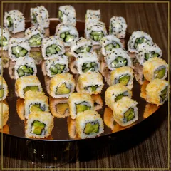We believe in culinary artistry. This platter of freshly prepared avocado and cucumber sushi rolls showcases our commitment to beautiful presentation and high-quality ingredients for our global cuisine offerings.