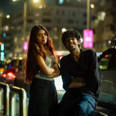 A posed group shot against a backdrop of traffic and city lights. This has a cool, urban-editorial feel.