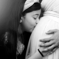 Sometimes, the most powerful stories are told without a single word. This tender black and white moment of a big sister's kiss is a perfect example of a family maternity picture, filled with love and anticipation for the new arrival.